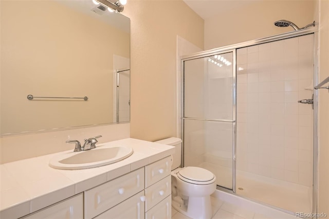 full bathroom with vanity, visible vents, a tile shower, tile patterned floors, and toilet