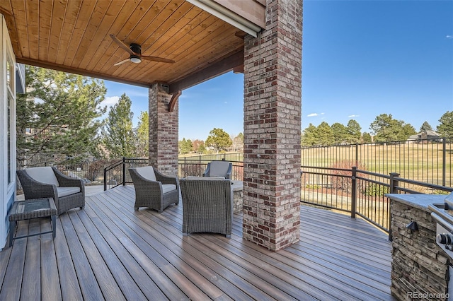 wooden deck with a ceiling fan