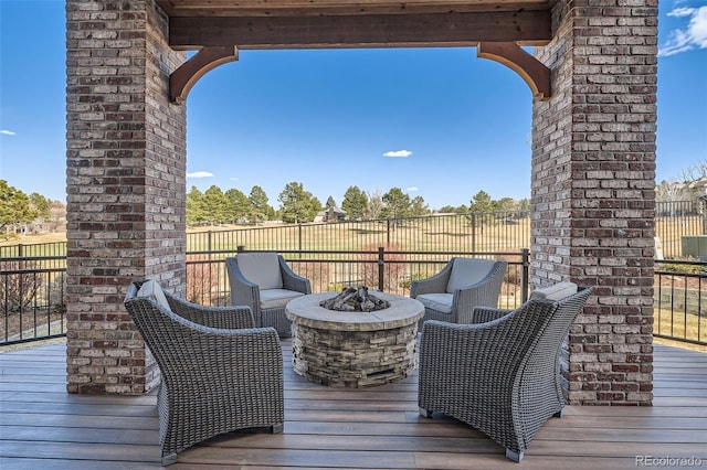 deck featuring a fire pit and fence