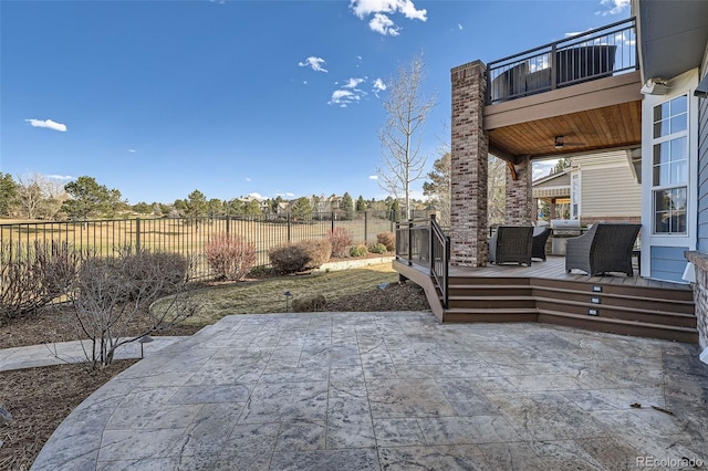 view of patio / terrace featuring a balcony and a fenced backyard