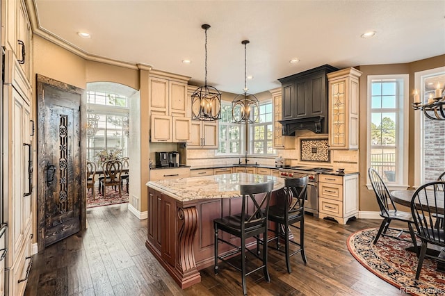 kitchen featuring a kitchen island, stainless steel stove, decorative backsplash, a chandelier, and dark wood-style flooring