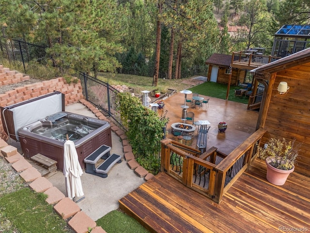 exterior space featuring outdoor dining area, a deck, and a hot tub