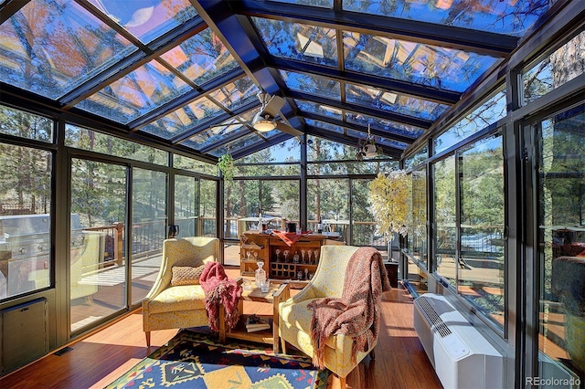 sunroom / solarium with plenty of natural light, ceiling fan, and lofted ceiling