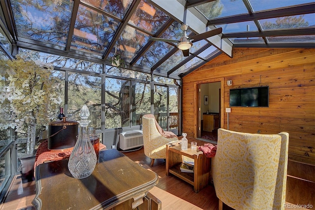 sunroom / solarium with lofted ceiling with beams and a ceiling fan