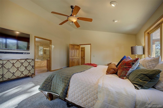 carpeted bedroom with connected bathroom, ceiling fan, baseboards, and vaulted ceiling