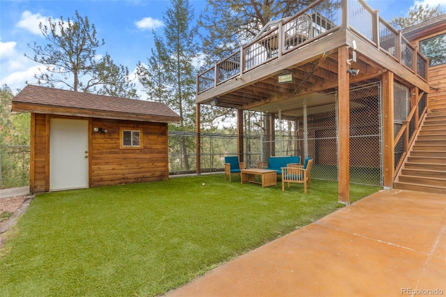 view of yard featuring an outbuilding, stairway, and a deck