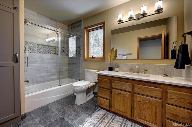 bathroom featuring decorative backsplash, enclosed tub / shower combo, toilet, and vanity