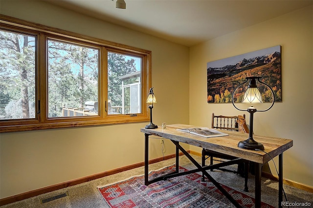 carpeted office featuring baseboards and visible vents