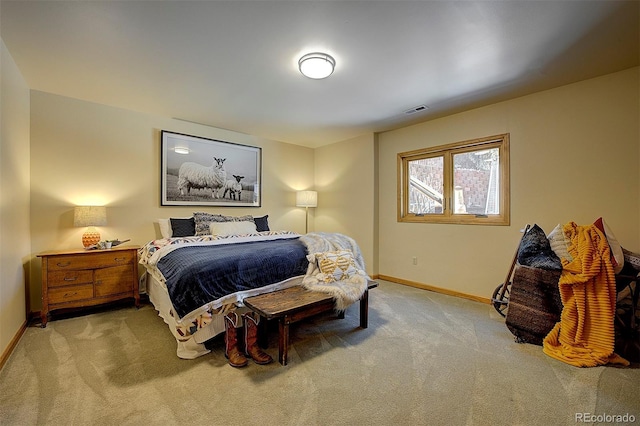 carpeted bedroom with baseboards and visible vents