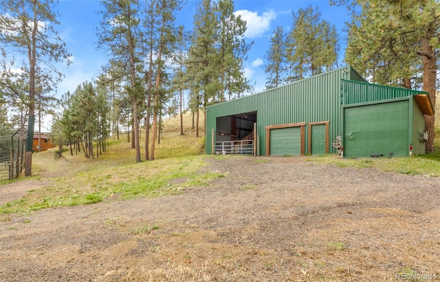 view of pole building featuring driveway