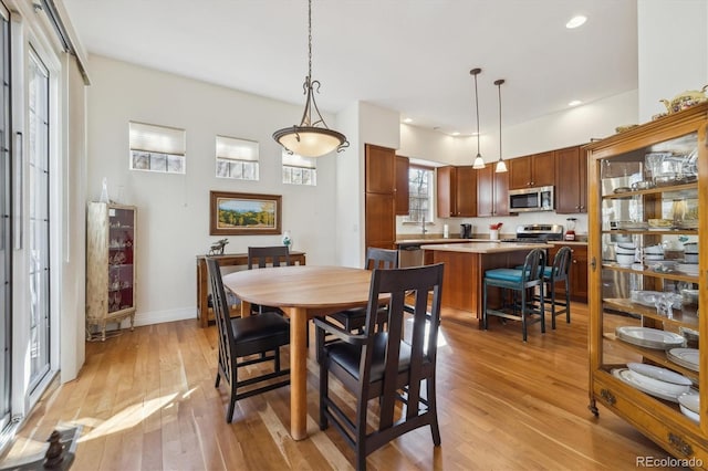 dining area with recessed lighting, baseboards, and light wood-style floors