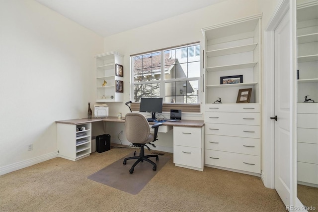 home office featuring baseboards and light colored carpet