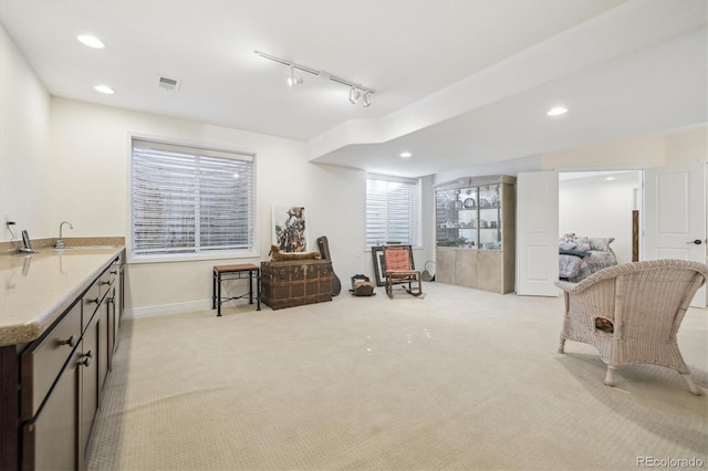 living area featuring baseboards, visible vents, recessed lighting, rail lighting, and light carpet