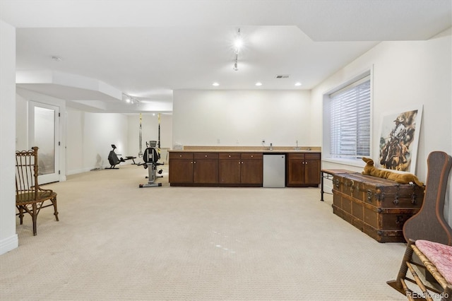 interior space featuring recessed lighting, visible vents, wet bar, and light carpet