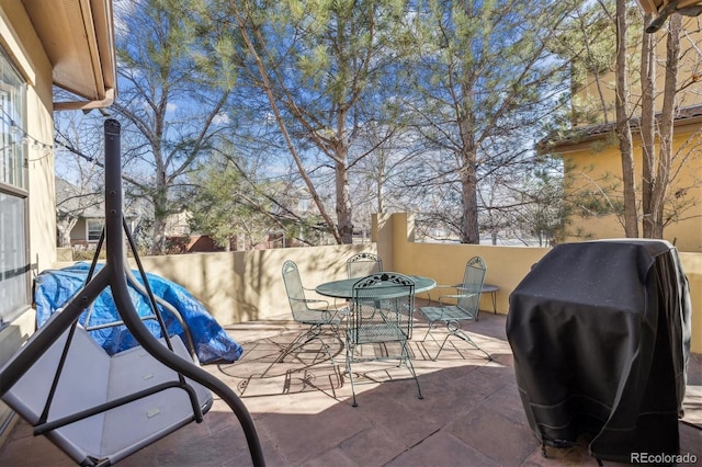 view of patio / terrace featuring outdoor dining space and a grill