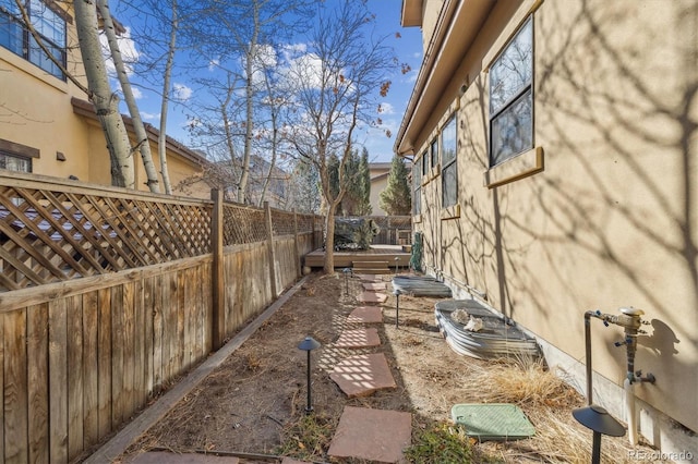 view of yard with a deck and fence