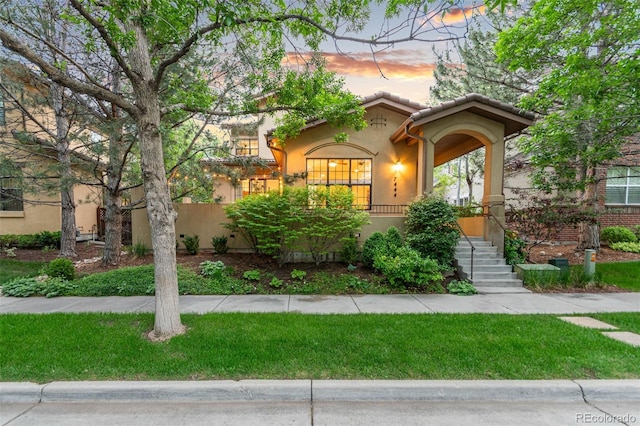 7444 E 9th Ave, Denver, CO 80230 - mediterranean / spanish home with stucco siding, a tile roof, and a front yard