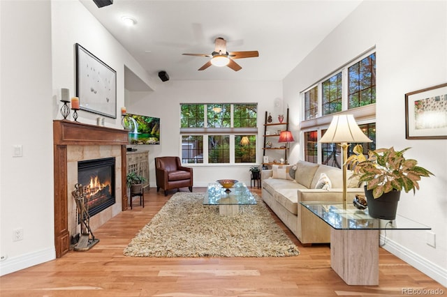 7444 E 9th Ave, Denver, CO 80230 - living room featuring a tiled fireplace, baseboards, and plenty of natural light