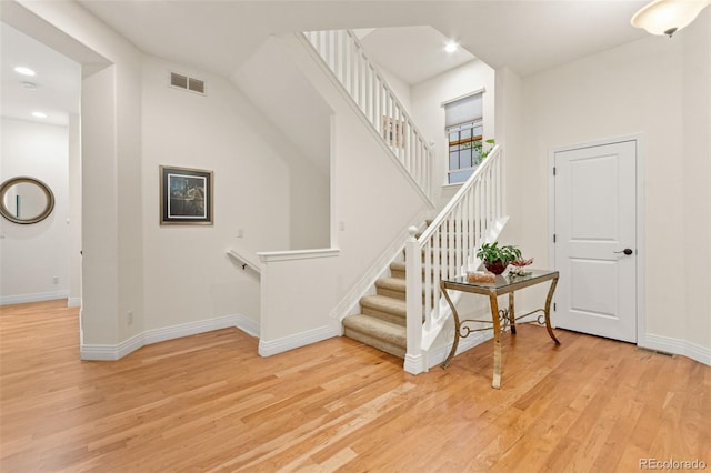 7444 E 9th Ave, Denver, CO 80230 - stairs featuring wood finished floors, baseboards, and recessed lighting