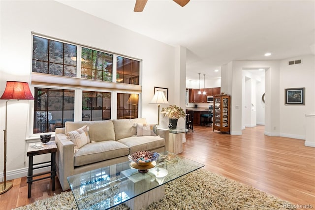 7444 E 9th Ave, Denver, CO 80230 - living area featuring light wood-type flooring, a ceiling fan, baseboards, and recessed lighting