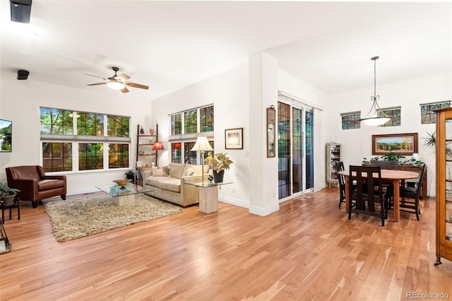 7444 E 9th Ave, Denver, CO 80230 - living area featuring light wood-type flooring, plenty of natural light, baseboards, and a ceiling fan