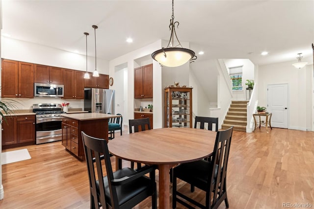 7444 E 9th Ave, Denver, CO 80230 - dining area with light wood-style flooring, stairs, and recessed lighting