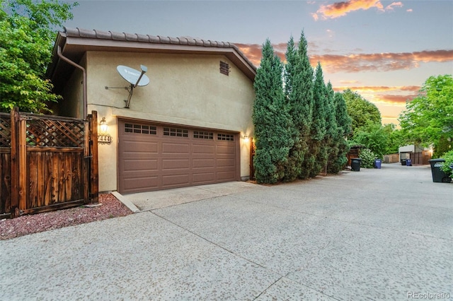 7444 E 9th Ave, Denver, CO 80230 - view of front of property with a garage, stucco siding, and driveway