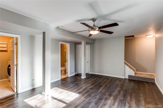 interior space with washer / dryer, ceiling fan, and dark hardwood / wood-style floors