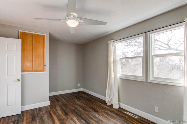 spare room with ceiling fan and dark hardwood / wood-style floors