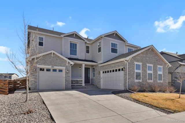 craftsman house featuring a garage, concrete driveway, and stone siding