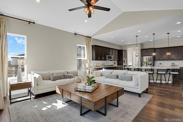 living room with lofted ceiling, ceiling fan, dark wood-type flooring, and recessed lighting