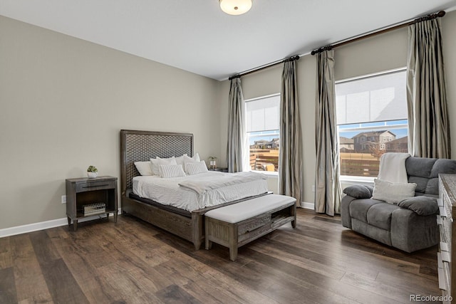 bedroom with dark wood finished floors and baseboards