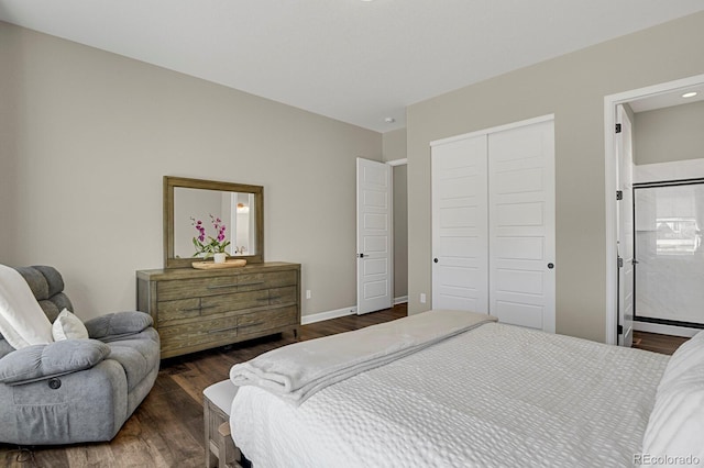 bedroom with dark wood-style floors, a closet, and baseboards