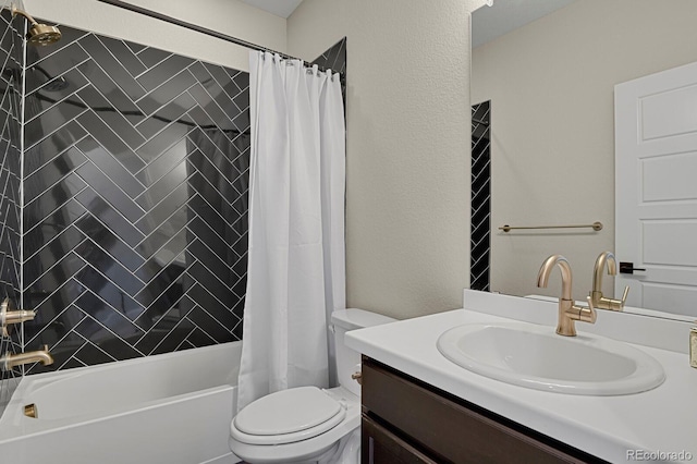 bathroom featuring a textured wall, shower / tub combo, vanity, and toilet