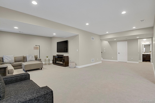 carpeted living room with recessed lighting, visible vents, and baseboards