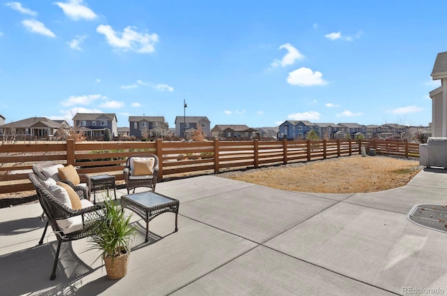 view of patio / terrace featuring a residential view and fence