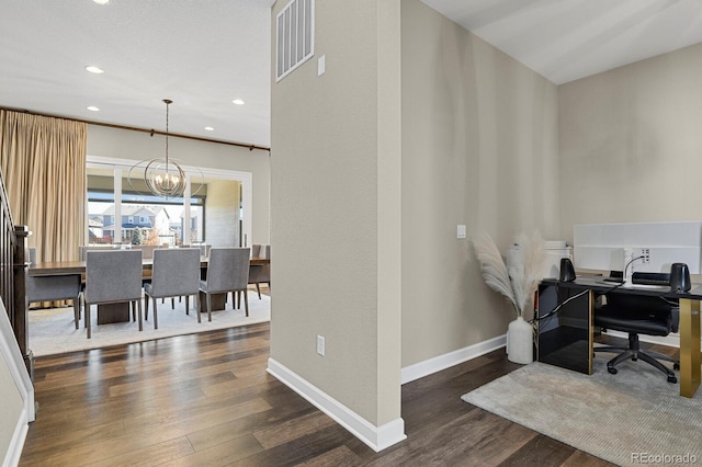 office area featuring a notable chandelier, wood finished floors, visible vents, and baseboards