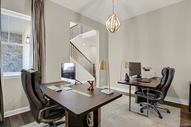 home office featuring a chandelier, baseboards, and wood finished floors