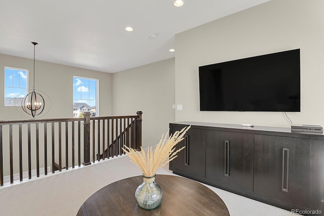 hallway with a chandelier, recessed lighting, and an upstairs landing