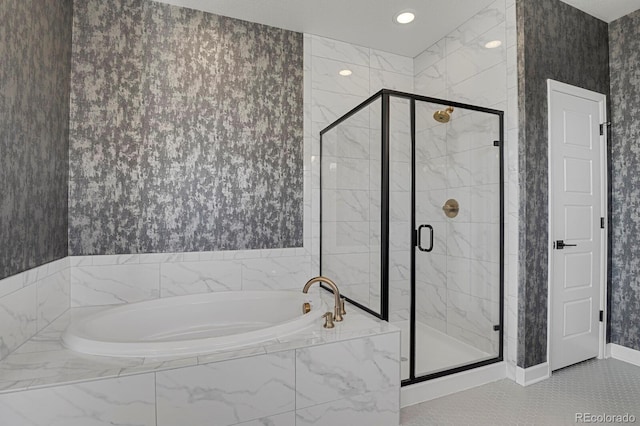 bathroom with a stall shower, wallpapered walls, baseboards, and a bath