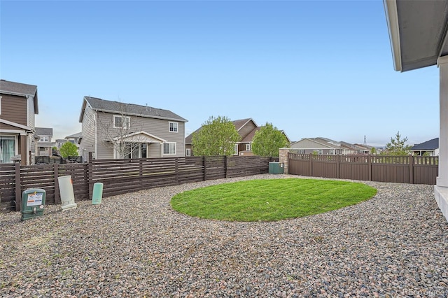 view of yard with a residential view and a fenced backyard