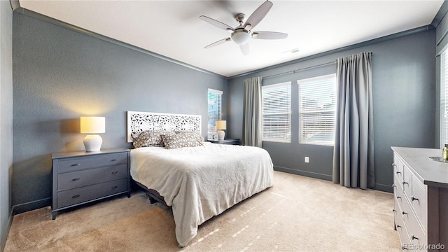 bedroom featuring light carpet, ceiling fan, visible vents, and baseboards