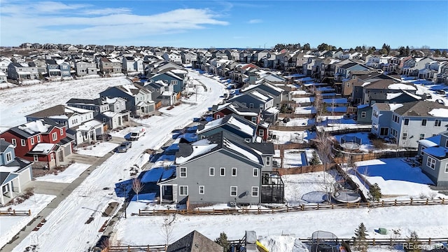 snowy aerial view with a residential view