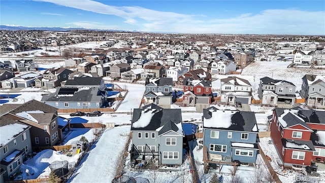 snowy aerial view featuring a residential view