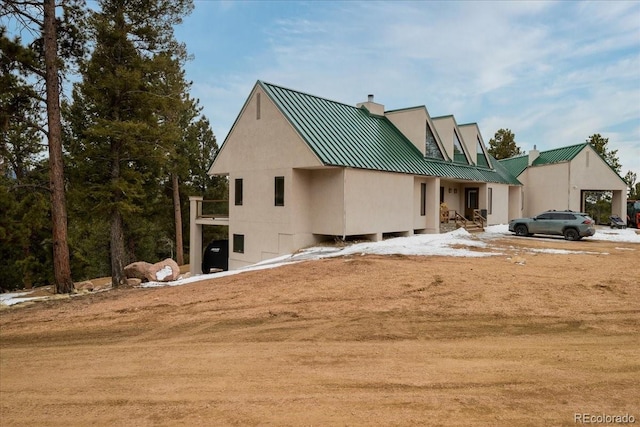 6900 US-24, Divide, CO 80814 - rear view of house with a chimney, a metal roof, and a standing seam roof