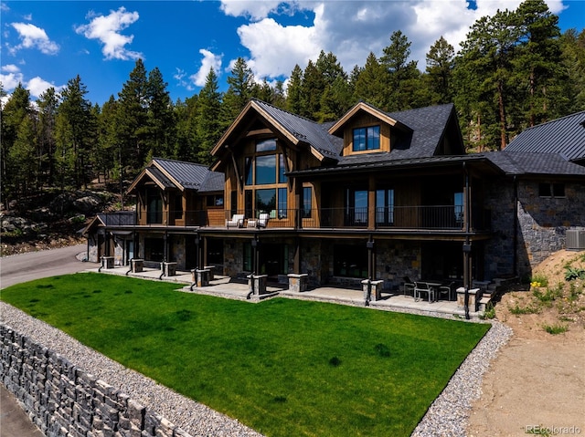 534 W Meadow Rd, Evergreen, CO 80439 - rear view of house featuring stone siding, a patio area, and a yard