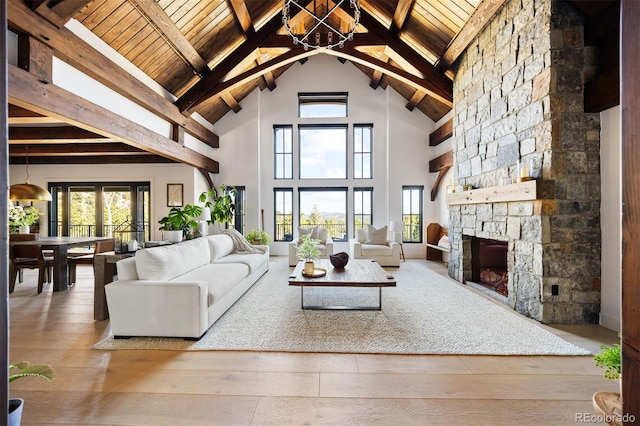 534 W Meadow Rd, Evergreen, CO 80439 - living area featuring wood-type flooring, a wood ceiling with exposed beams, high vaulted ceiling, a stone fireplace, and a chandelier