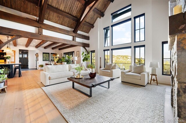 534 W Meadow Rd, Evergreen, CO 80439 - living room featuring high vaulted ceiling, a wooden ceiling with exposed beams, and light wood-style flooring