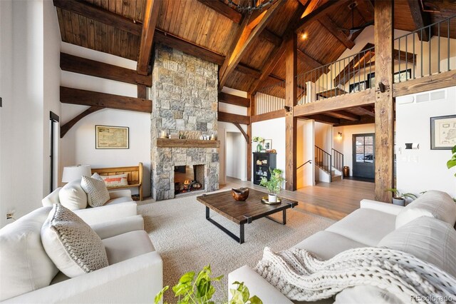 534 W Meadow Rd, Evergreen, CO 80439 - living room with a wood ceiling with exposed beams, high vaulted ceiling, stairway, wood finished floors, and a fireplace
