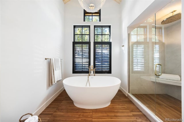 534 W Meadow Rd, Evergreen, CO 80439 - full bath featuring wood finished floors, a shower stall, and a freestanding bath